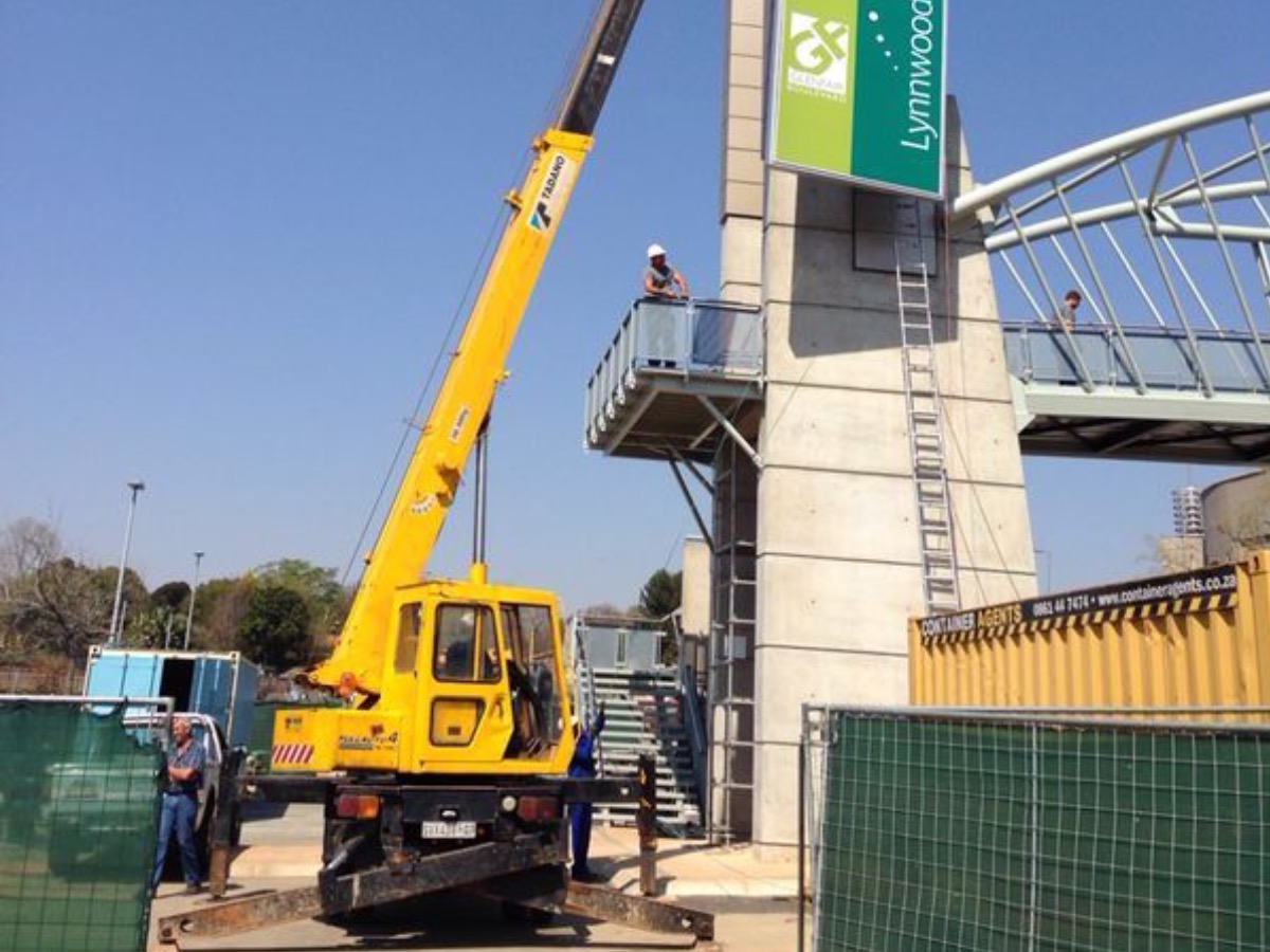Yellow Tadano mobile crane working at a pedestrian footbridge installation