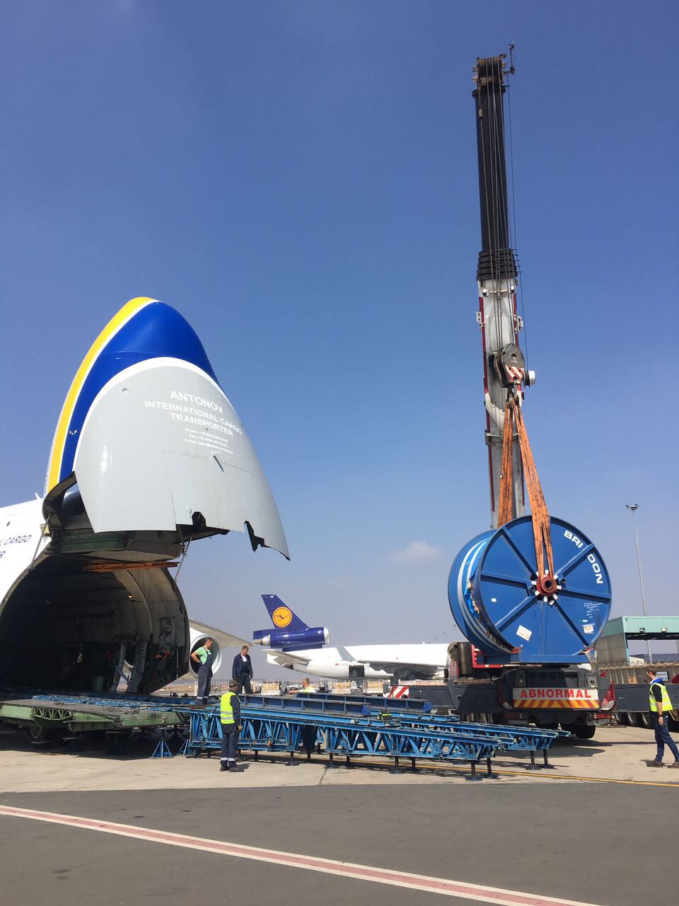 100-ton mobile crane lifting cargo at an Antonov heavy-cargo aircraft