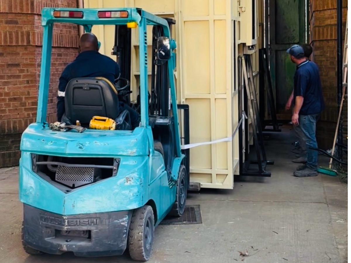 5-ton counterbalance forklift moving a container at a warehouse
