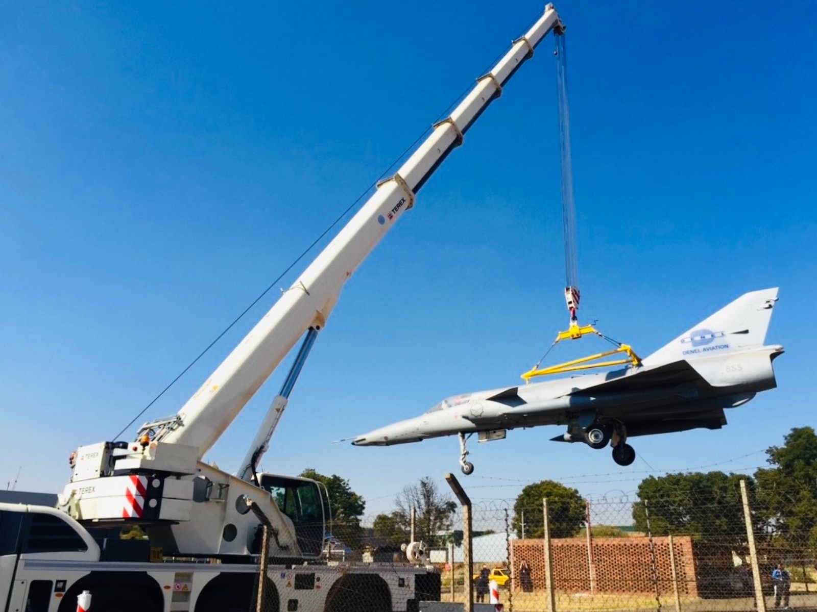 CMK mobile crane lifting an Atlas Cheetah aircraft for relocation
