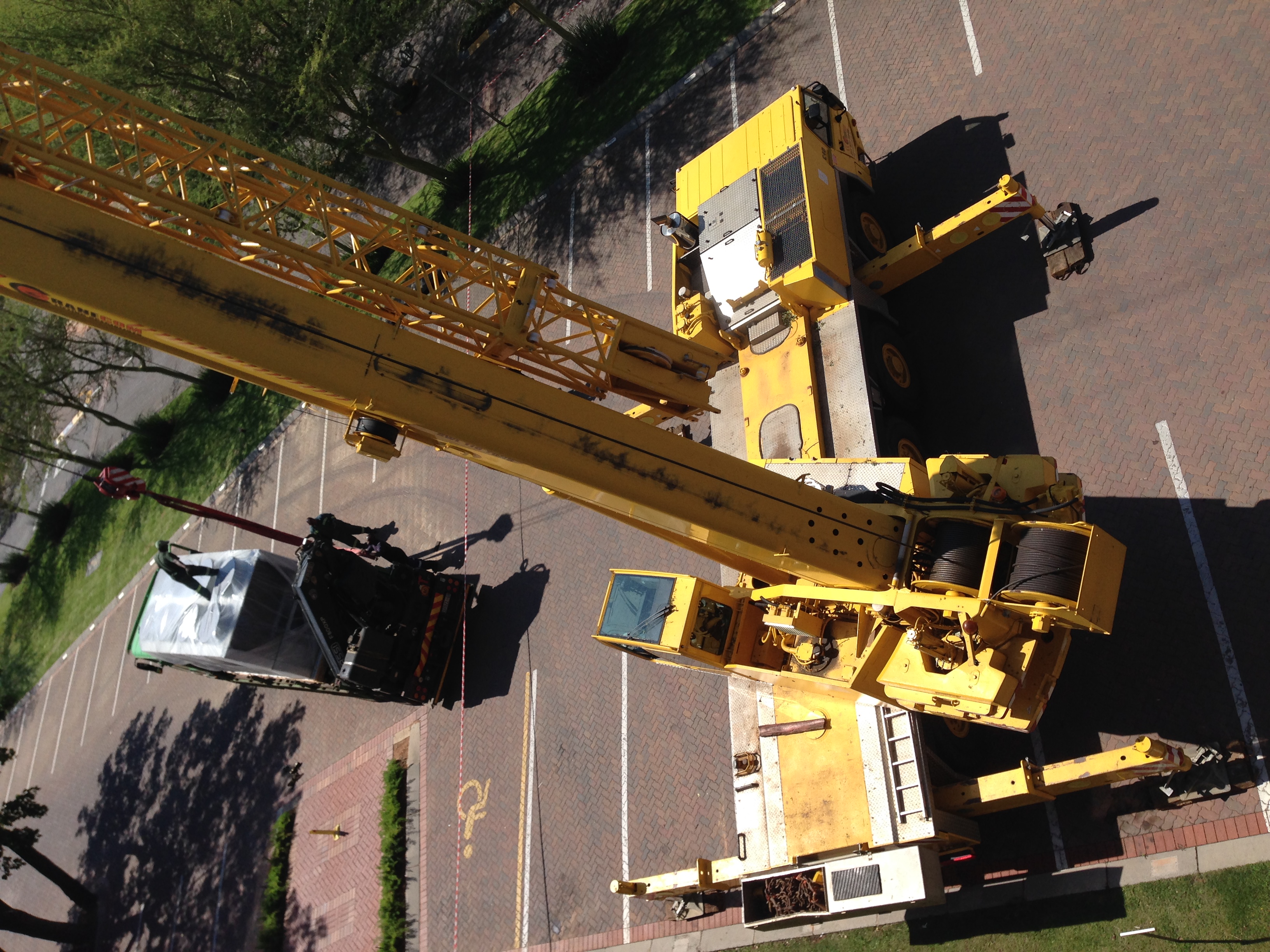 Mobile crane lifting an aircon unit onto a Johannesburg commercial rooftop