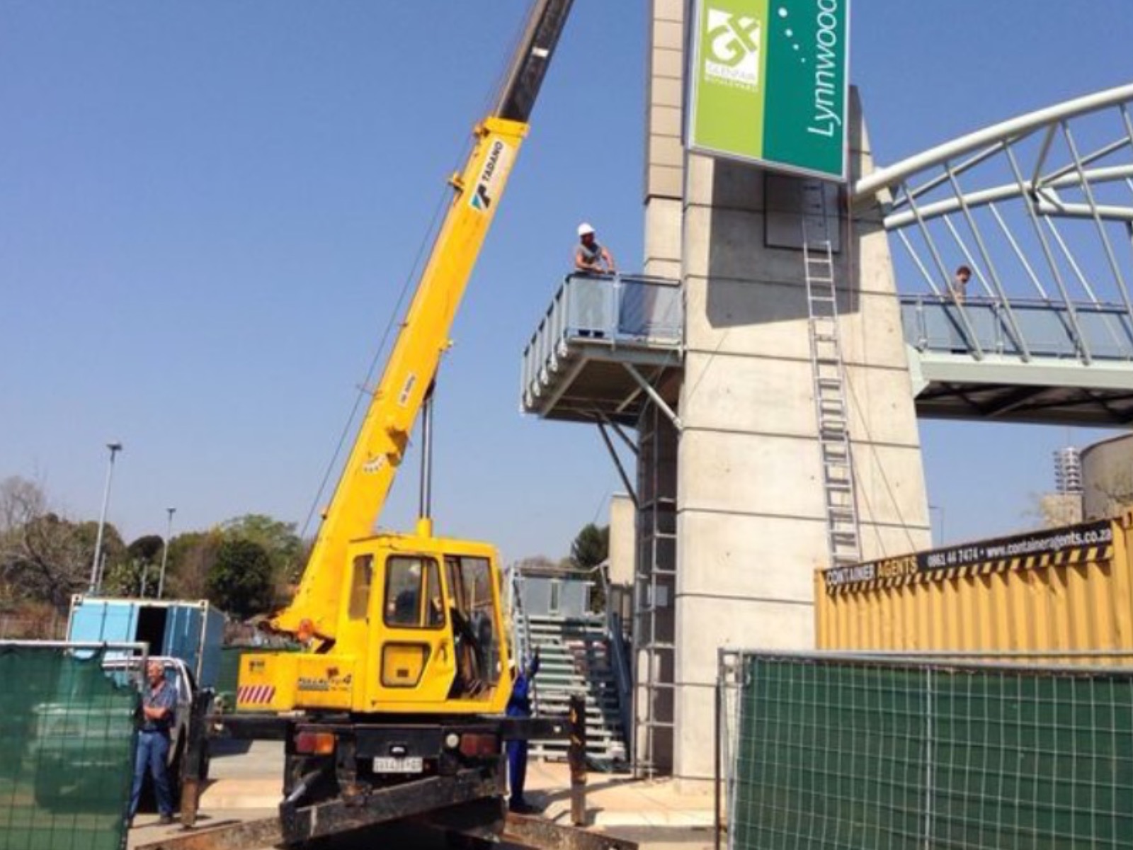 Small-band mobile crane on a signage installation job — typical small-crane work