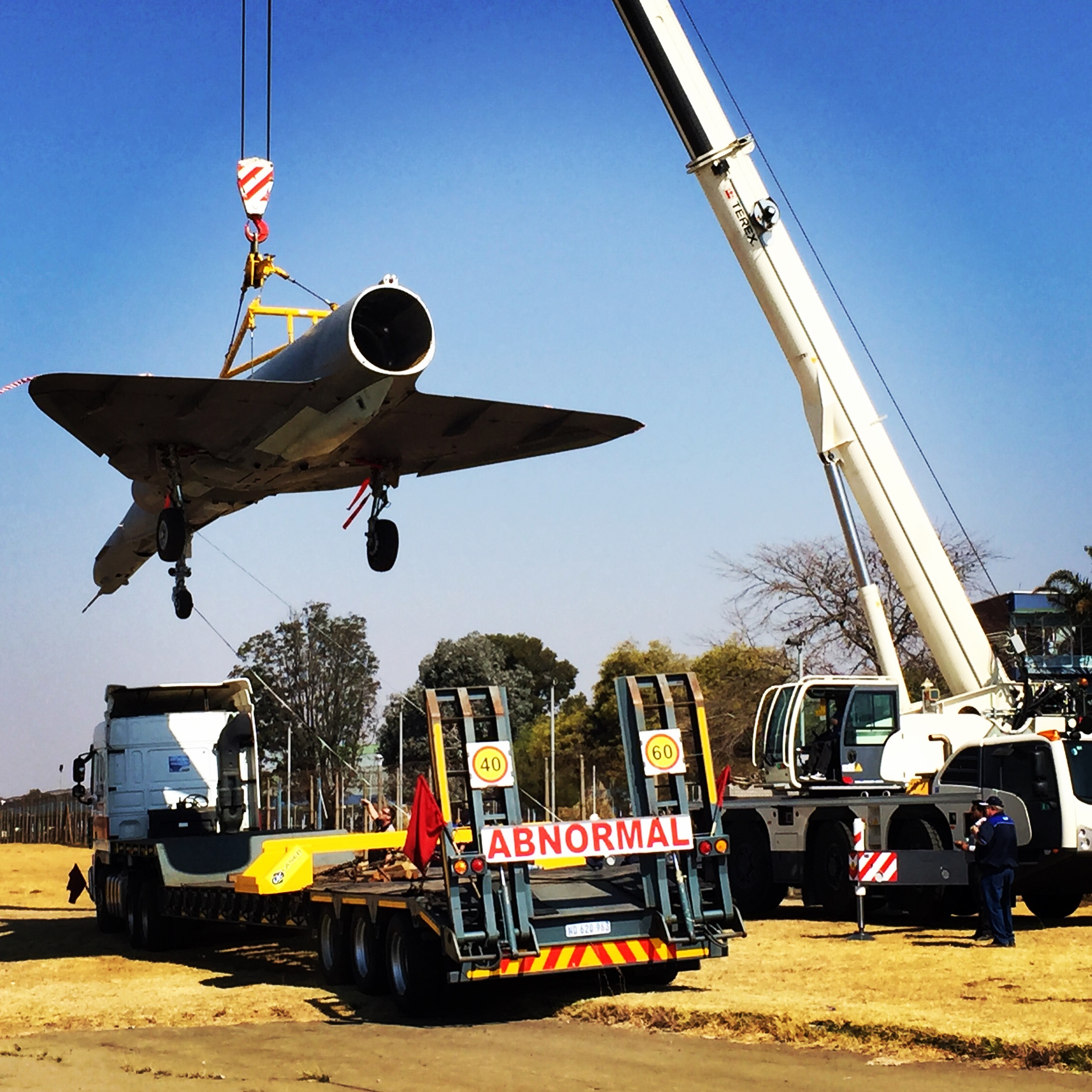 Atlas Cheetah aircraft being loaded onto a low-bed transport trailer